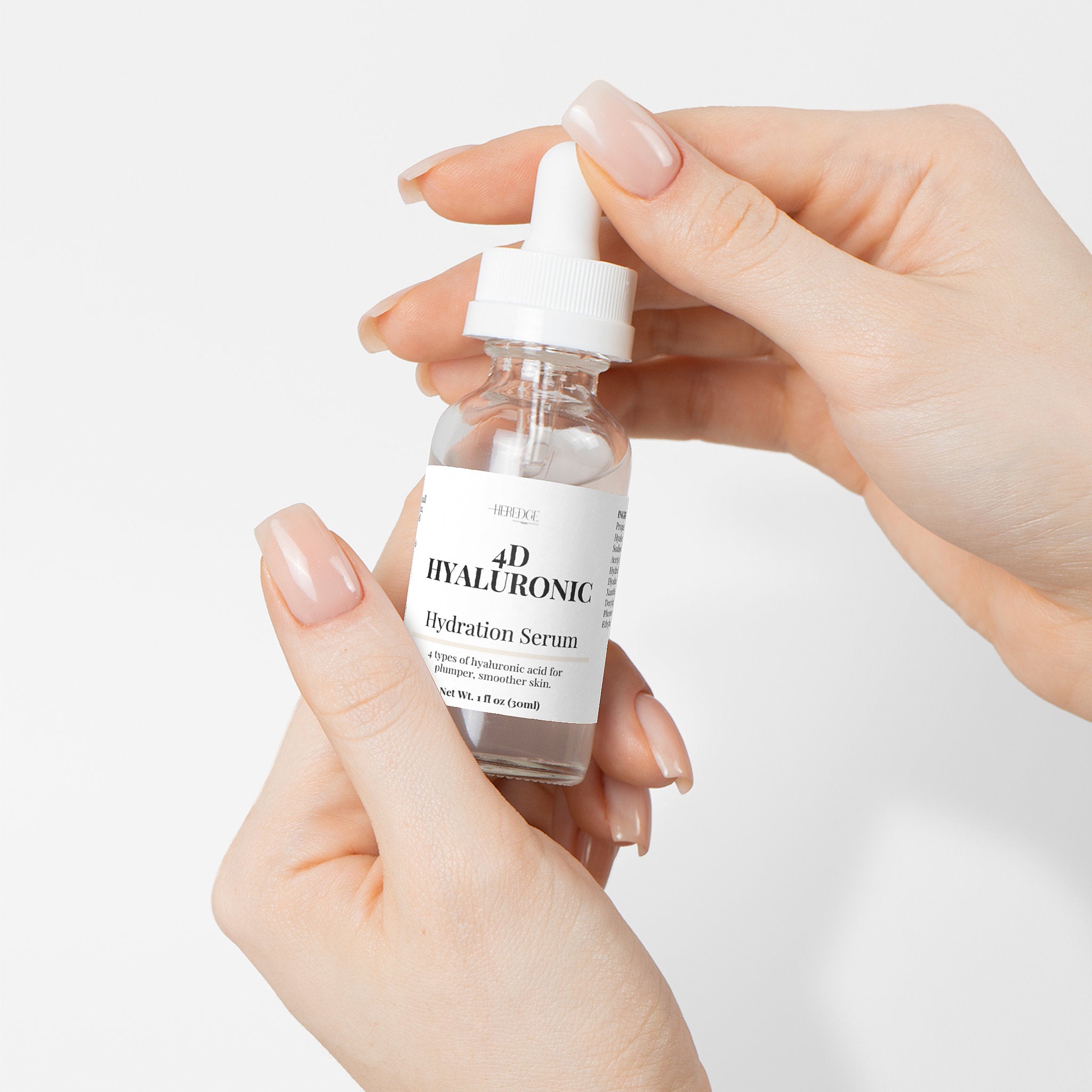 Hand holding a bottle of 4D Hyaluronic Hydration Serum against a light background