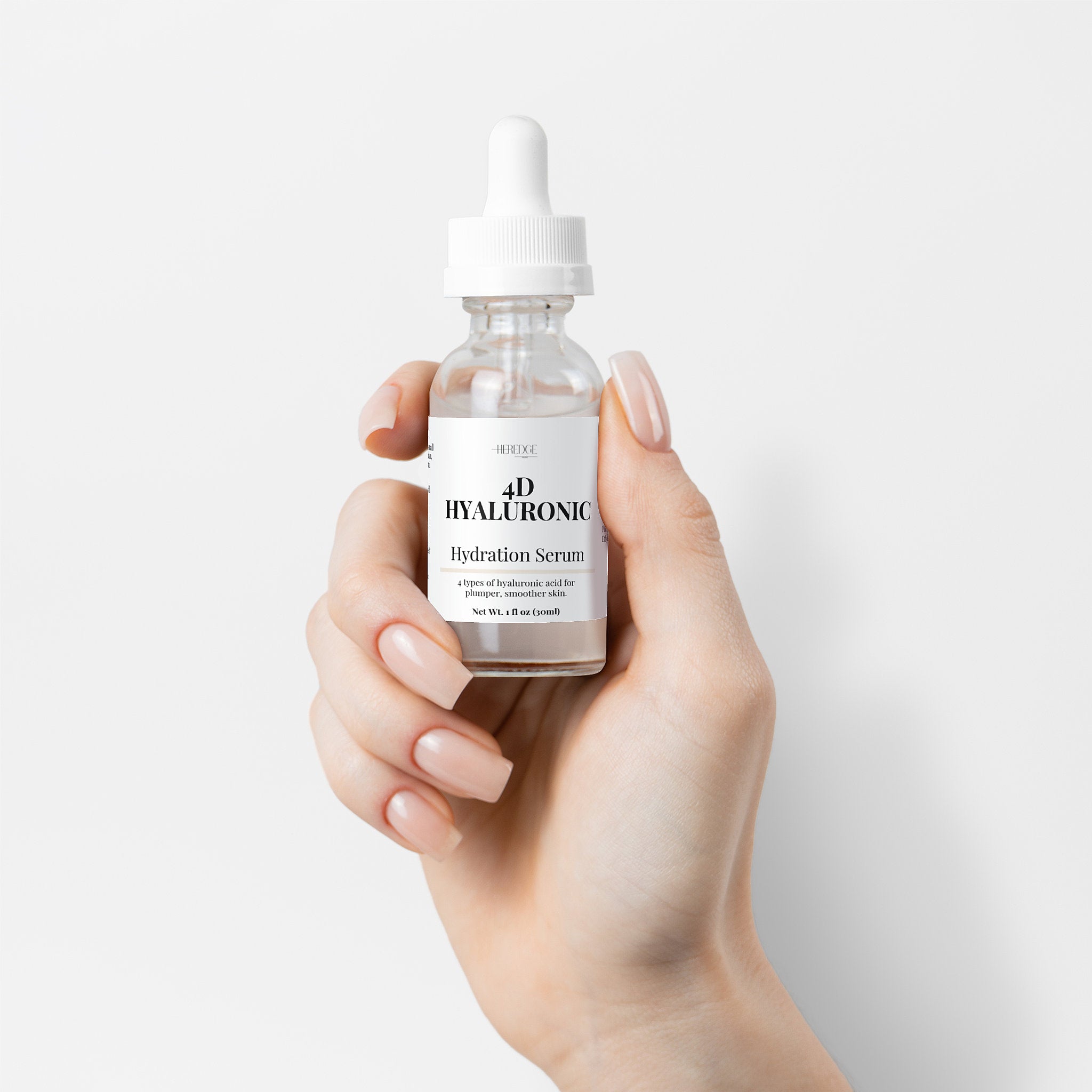 Hand holding a bottle of hyaluronic hydration serum against a light background