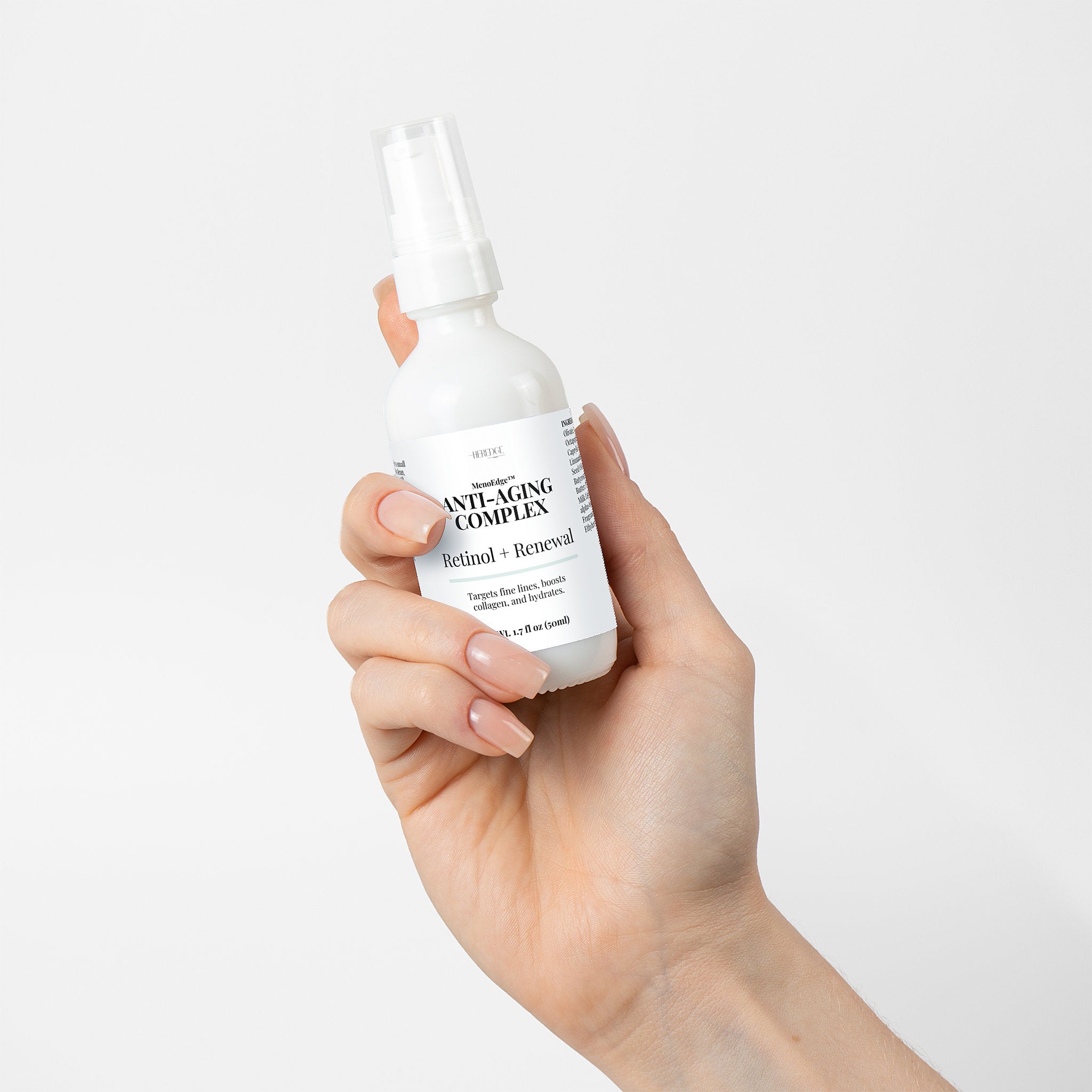 Hand holding a skincare serum bottle labeled 'Anti-Aging Complex' against a light background