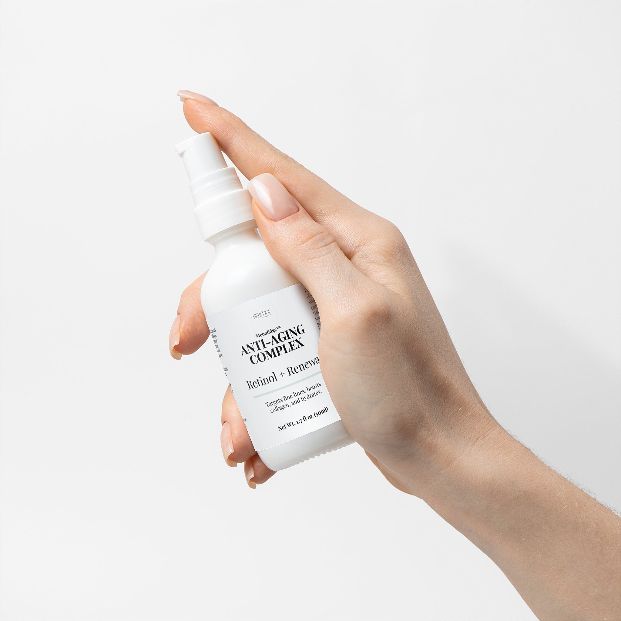 Hand holding a white bottle labeled 'Anti-Aging Complex' against a light background