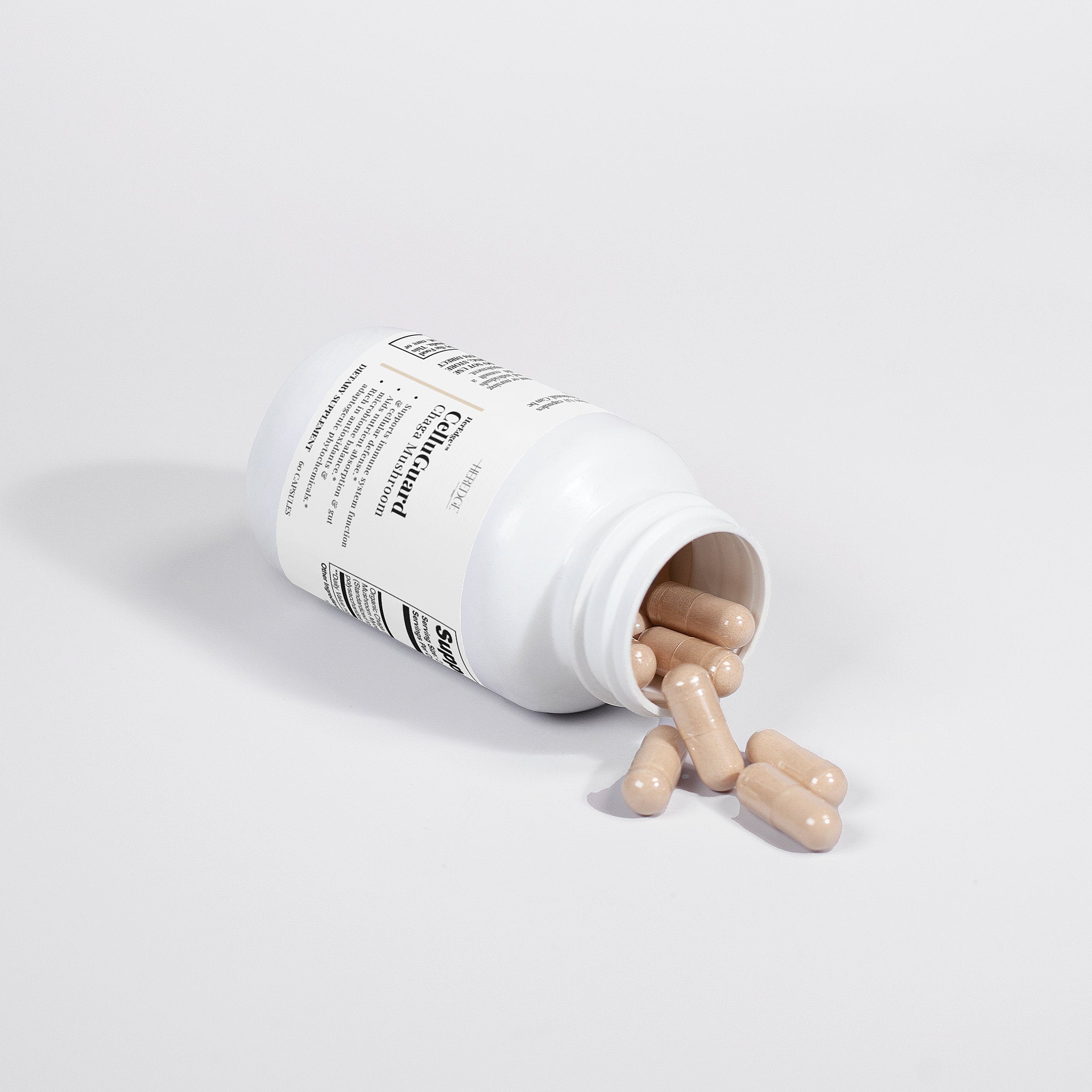 Supplement bottle with pills spilling out on a white background